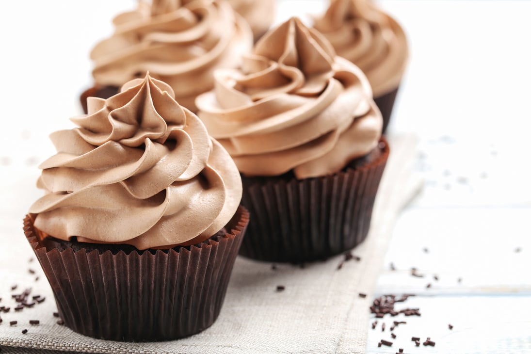 Tasty cupcakes on a white wooden table